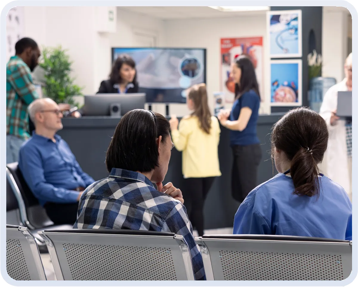 Patients arriving in a clinic lobby during peak check-in hours